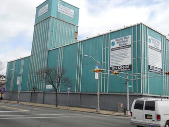 A building with a large blue wall on the side of it.