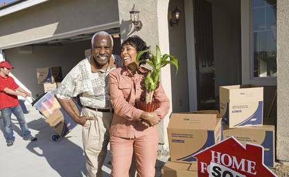 A man and woman standing in front of boxes.